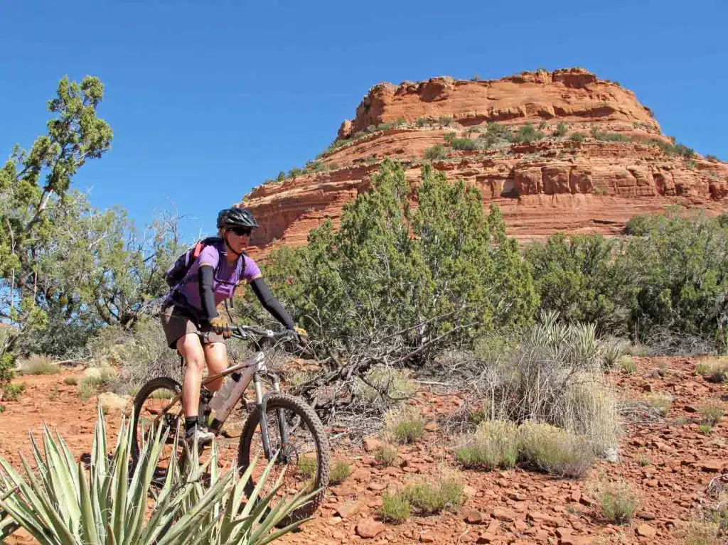 Woman mountain biking in the red rocks, Sedona, USA trails near Sevilla Sol Mobile Homes For Sale Peoria AZ